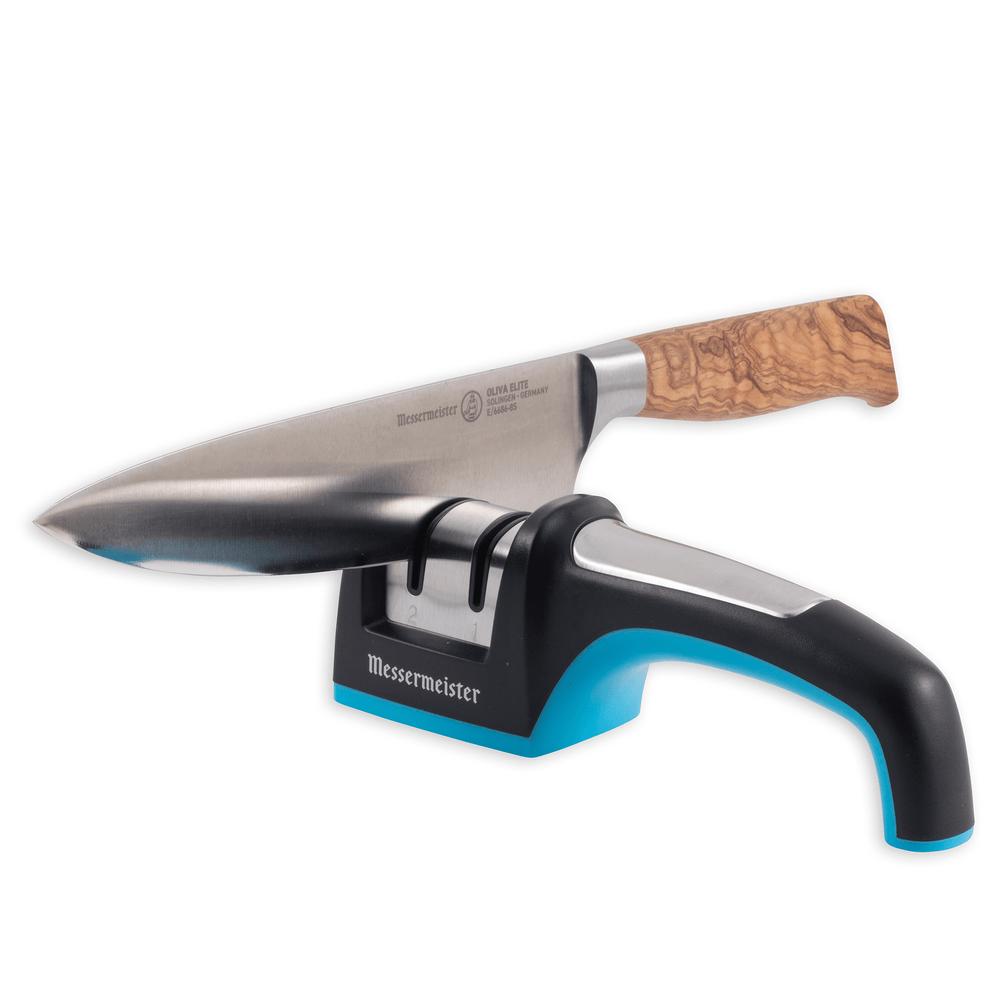 Messermeister Pull Through Knife Sharpener. Showing a full view of sharpener and a wood handled knife with blade inside the left side sharpening slot.