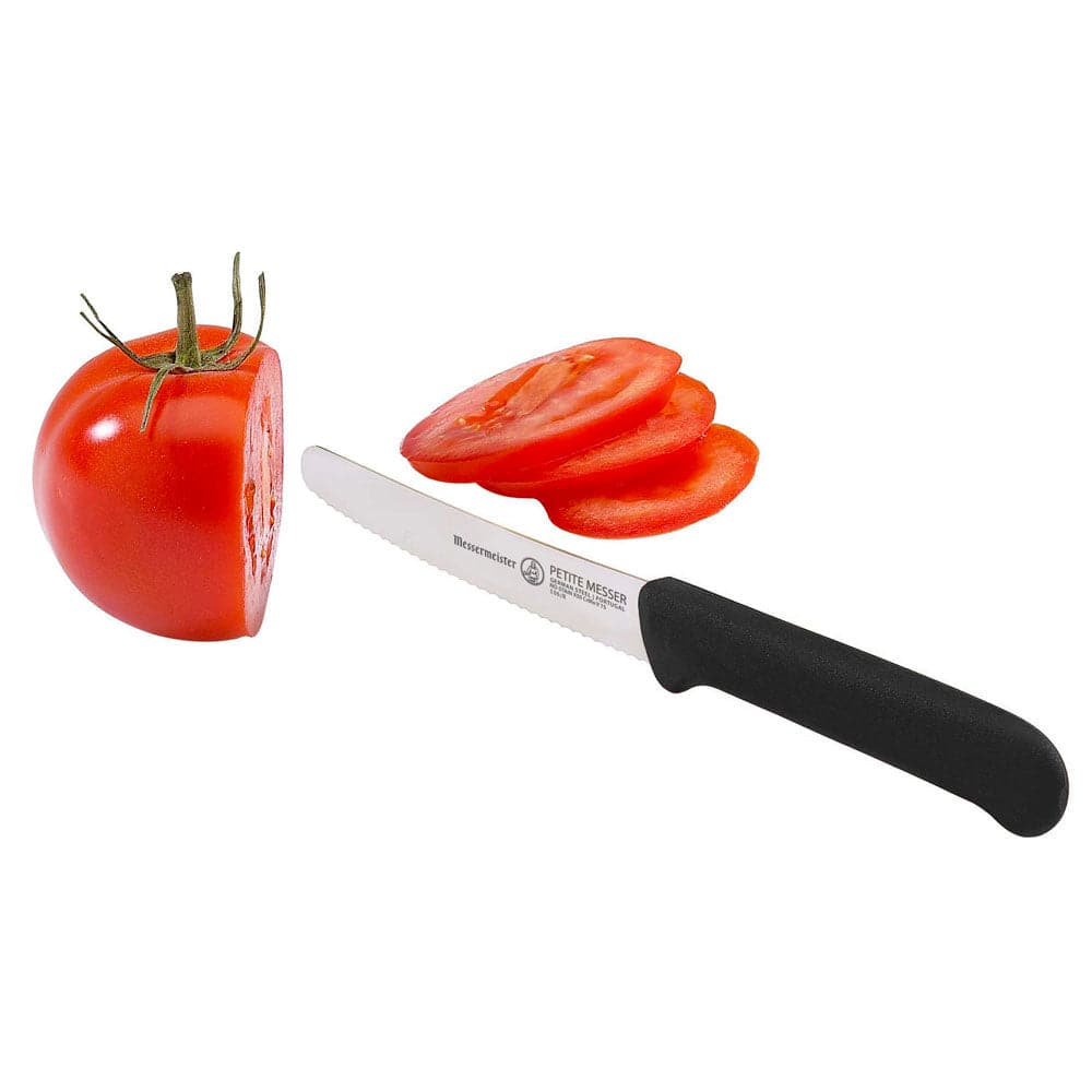 Black 4.5-inch serrated tomato knife cutting fresh tomato showing stainless steel blade designed for precise, smooth slicing