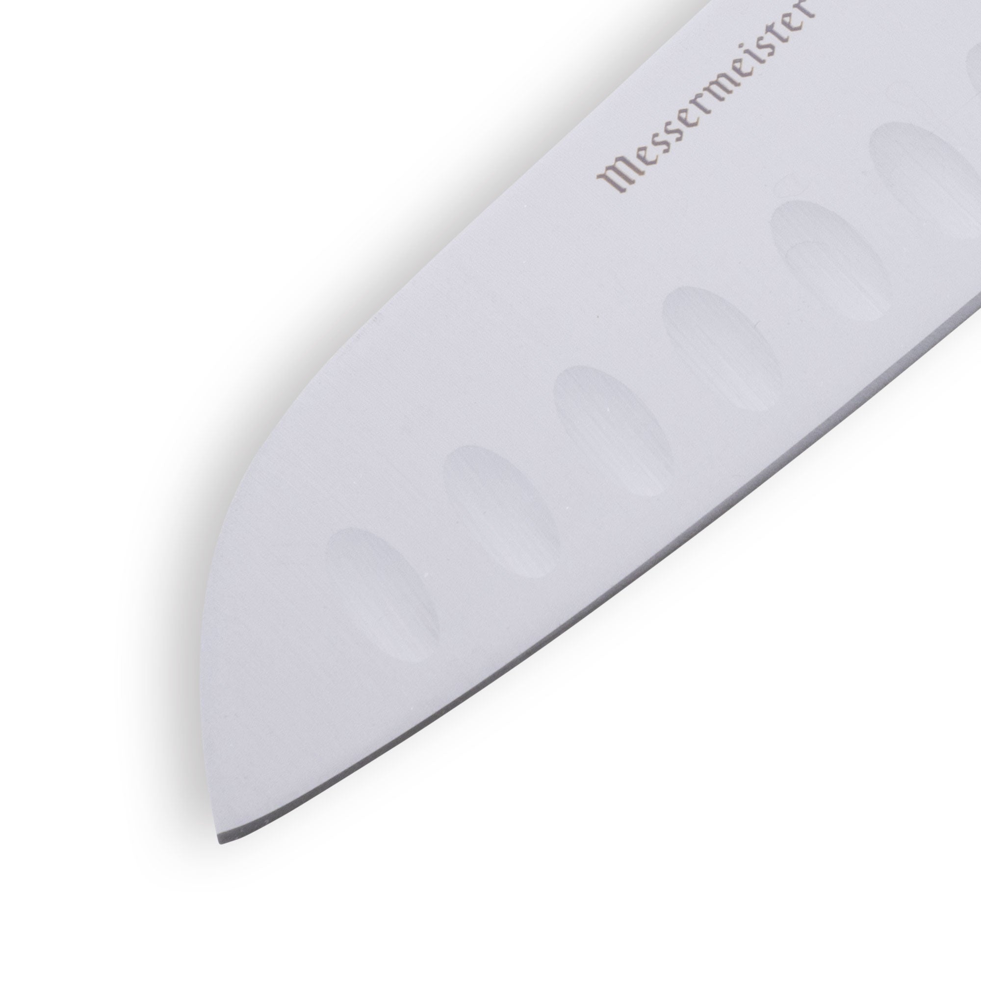 Precision tip of Petite Messer Green Santoku knife with granton edge visible