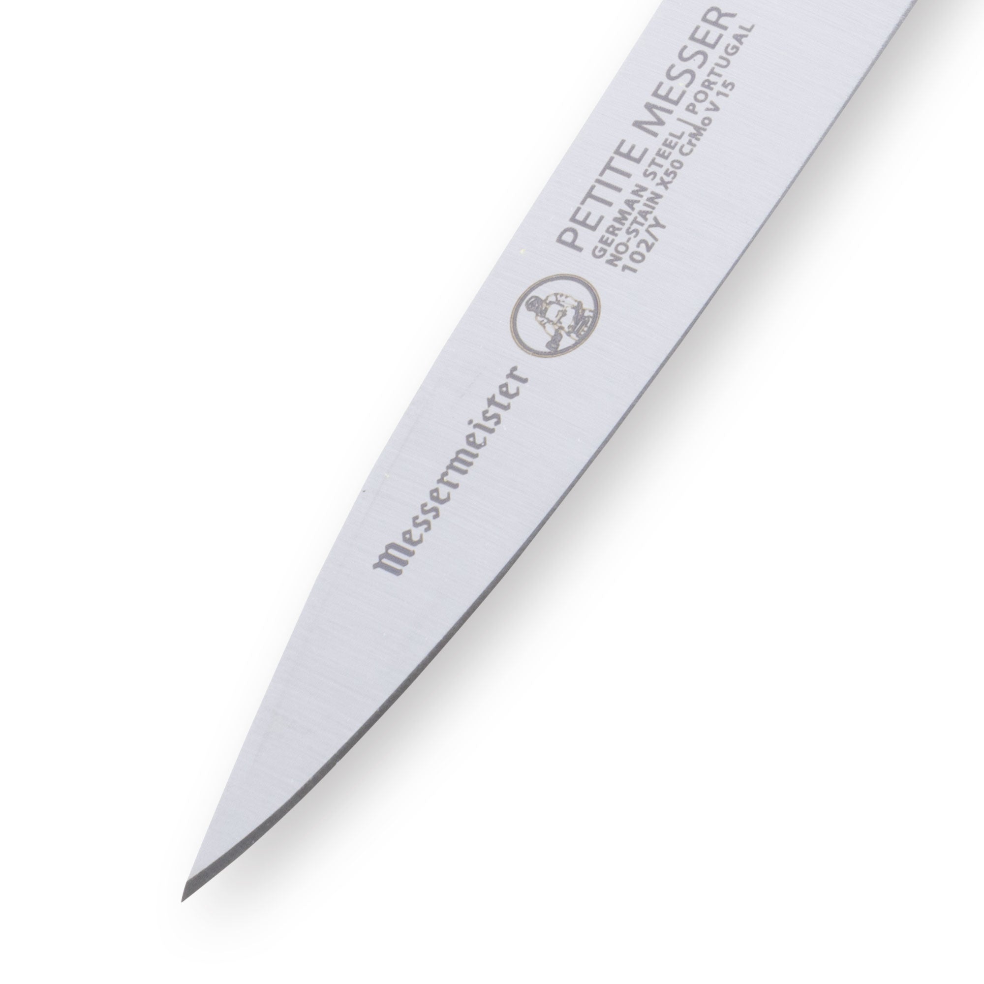 Close up of Messermeister Petite Messer yellow handled 3 inch spear point paring knife tip emphasizing sharp precision point for detailed prep work