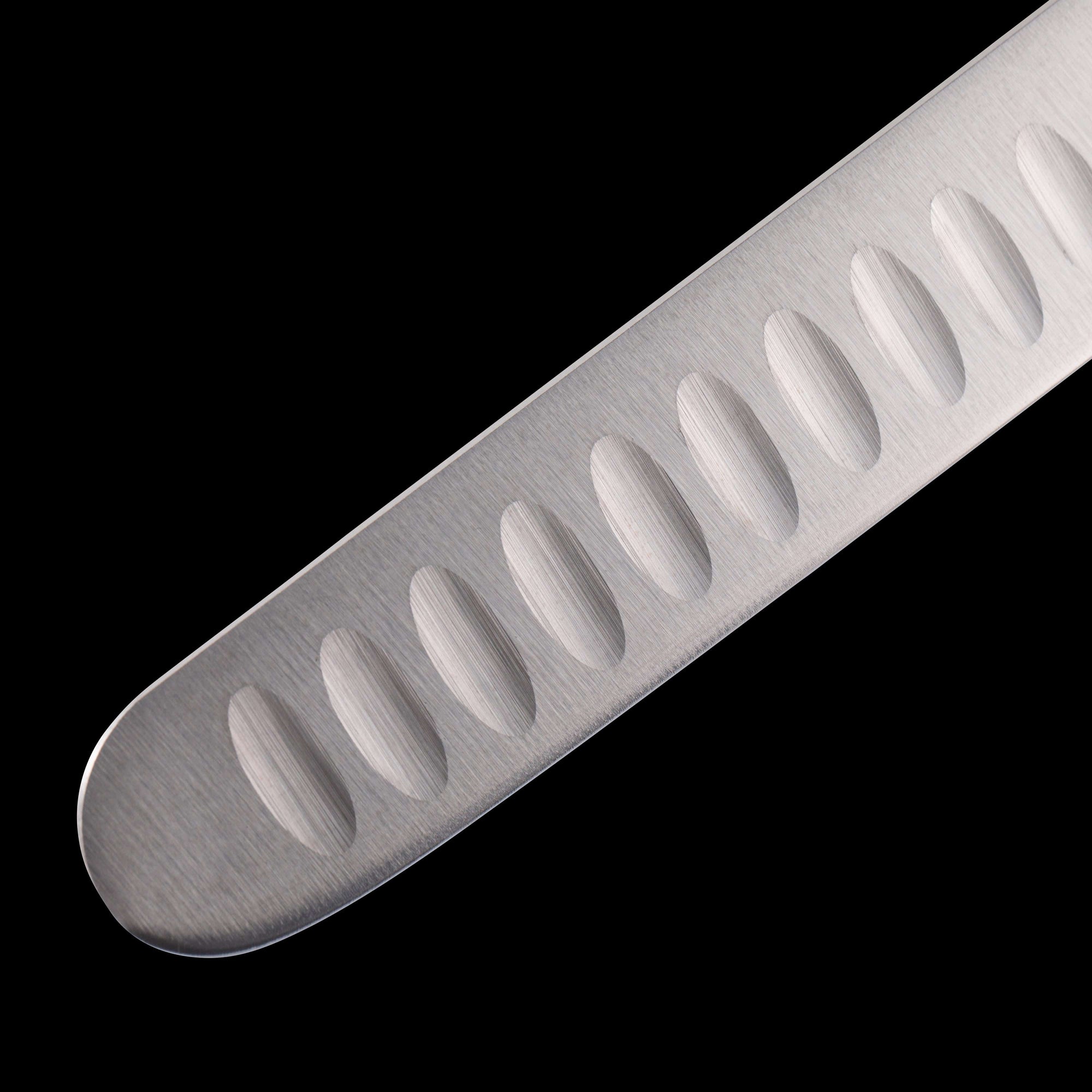 Close-up view of rounded blade tip on Messermeister Pro Series 12-inch kullens slicer showing granton edge for clean, even slices