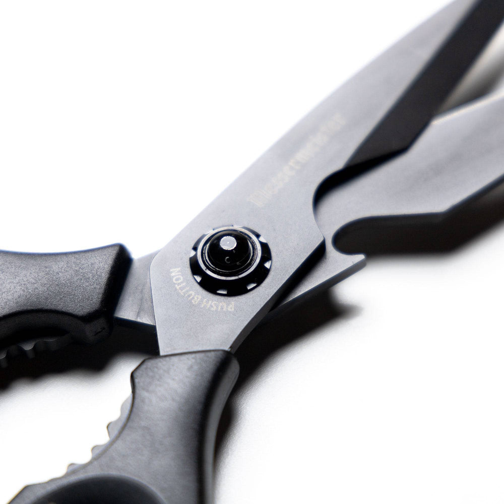Close-up of the push-button release mechanism on 9-inch take-apart shears, highlighting the secure locking system and easy-detach design for quick disassembly and cleaning.