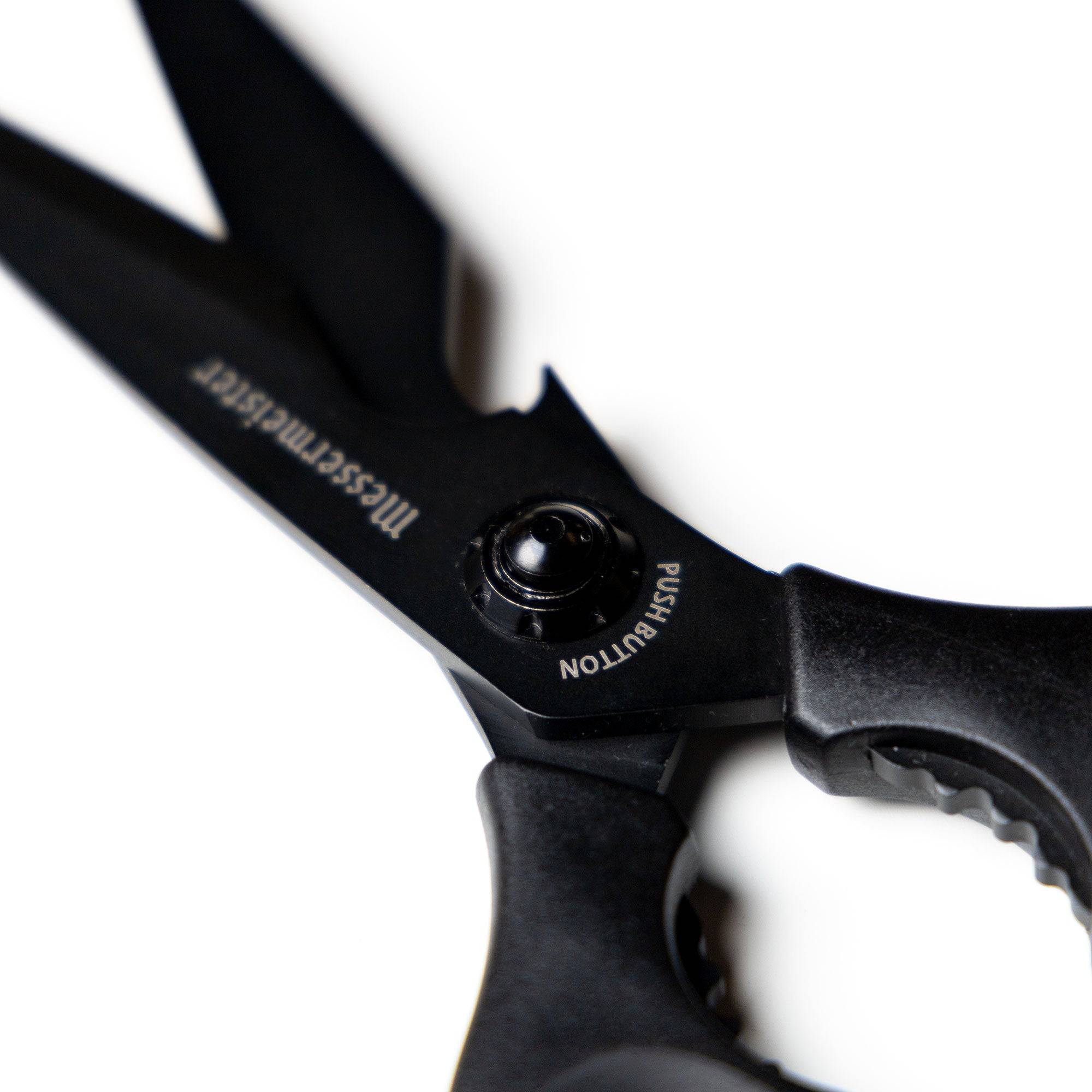 Close-up of the push-button release mechanism on 9-inch take-apart shears, highlighting the secure locking system and easy-detach design for quick disassembly and cleaning.