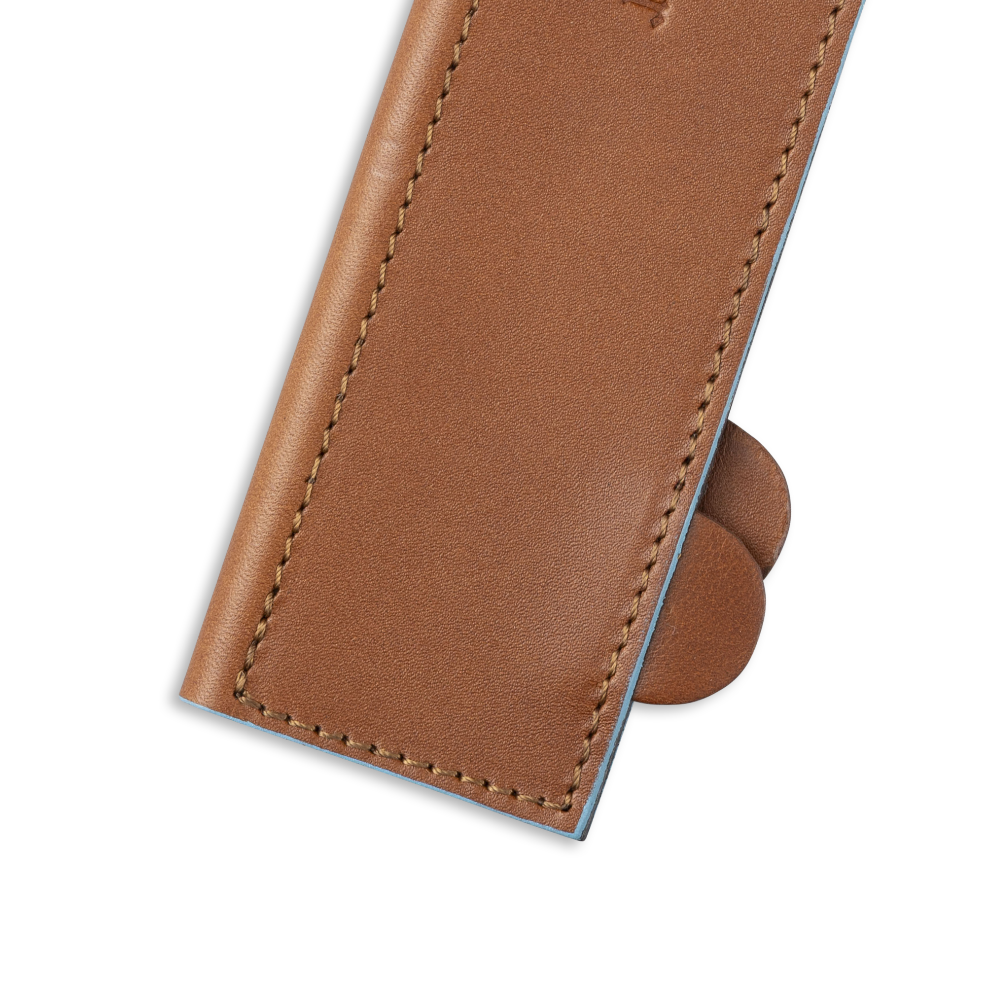 Messermeister 10.5 inch Saddle Brown Leather Magnetic Edge Guard Soft Rubber Magnets to Secure Knife on a plain background close up on opener tabs