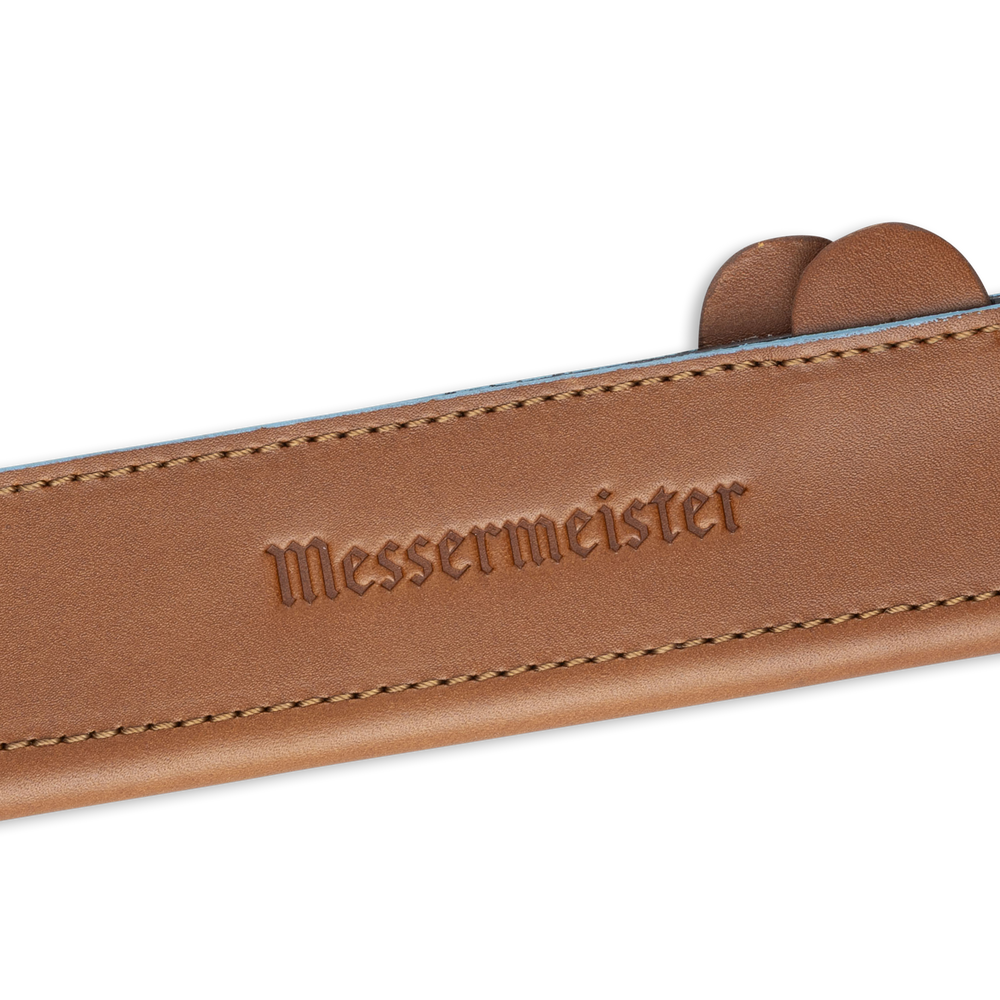 Messermeister 6.5 inch Saddle Brown Leather Magnetic Edge Guard Soft Rubber Magnets to Secure Knife close up on logo