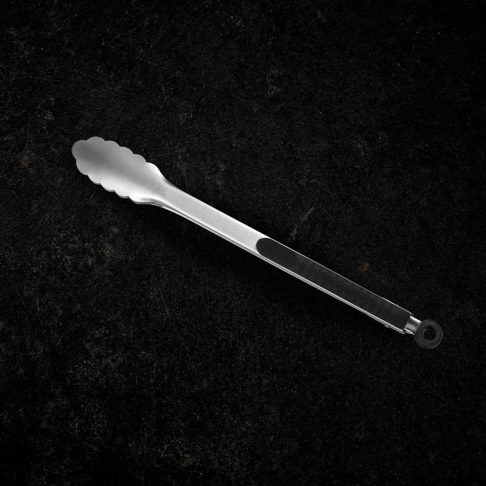 Messermeister 12 Inch Stainless Locking Tongs Full view showing resting on a counter