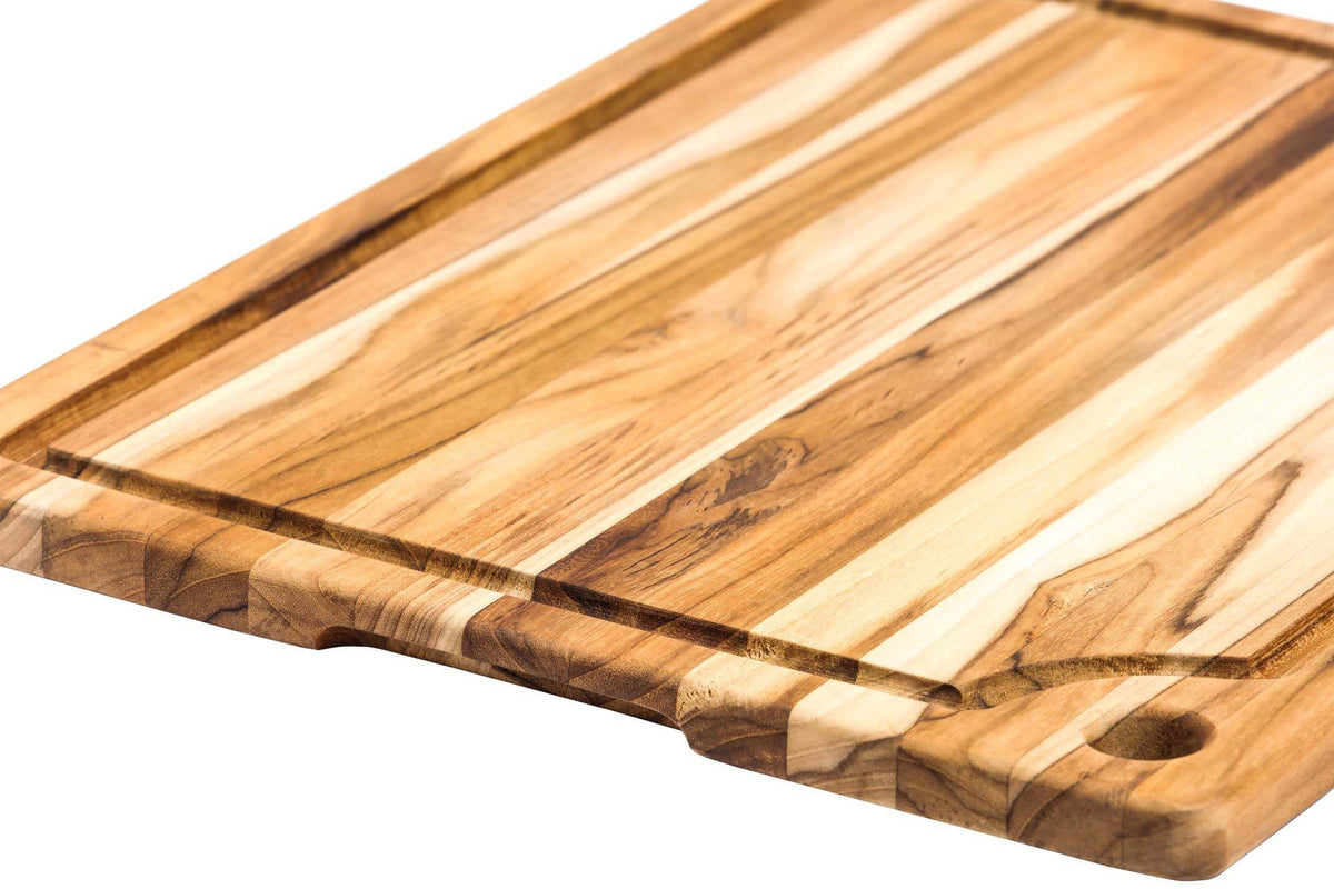 Top view of Teakhaus marine cutting board featuring a juice groove, handle grip, and hanging hole.