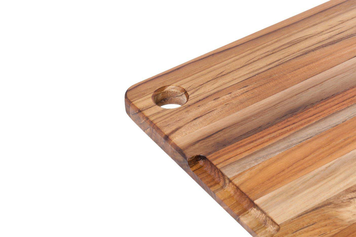 Close-up of the hanging hole and handle grip on the Teakhaus marine cutting board.