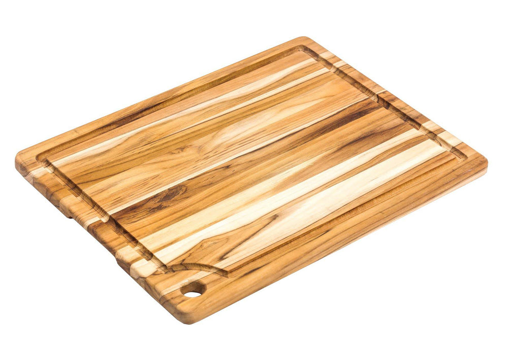 Top view of Teakhaus marine cutting board featuring a juice groove, hanging hole, and natural teak wood grain.
