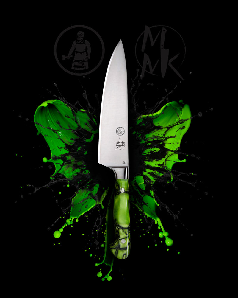 A professional chef's knife with a silver stainless steel blade and a green marbled handle, centered against a black background with a green paint splatter graphic and dark gray 'MK' logos.