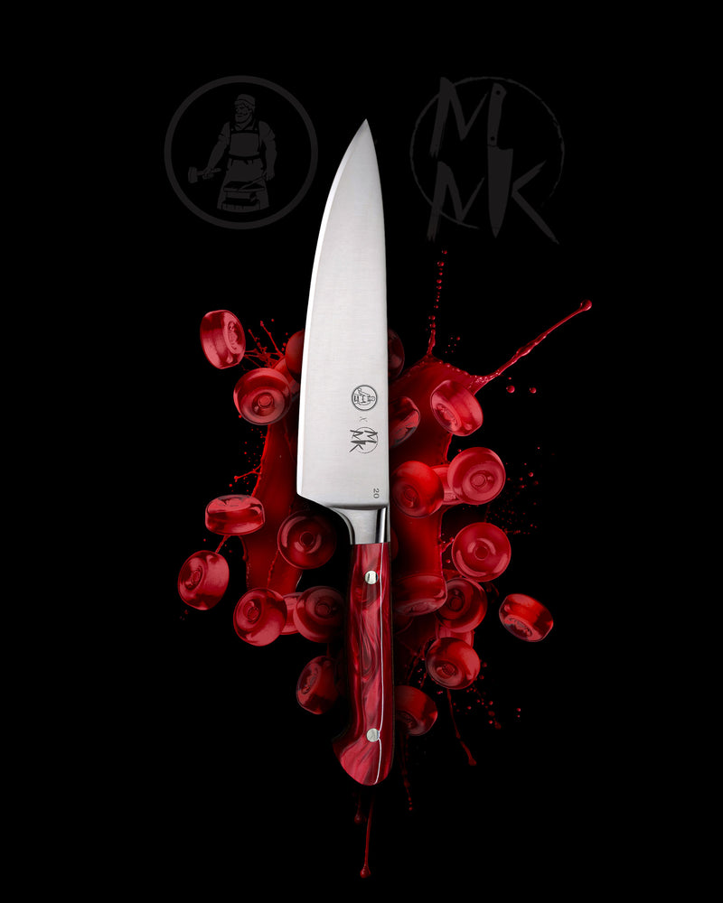 A professional chef's knife with a silver stainless steel blade and a red textured handle, presented vertically against a black background with a red blood splatter graphic and the MK logo.