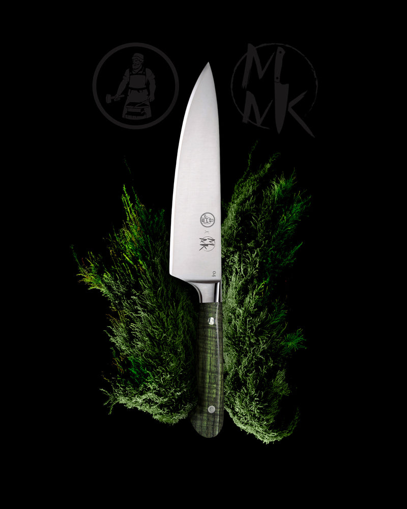 A chef's knife with a silver blade and a textured green handle, positioned vertically between two sprigs of fresh green herbs on a solid black background, with dark gray brand logos in the upper background.