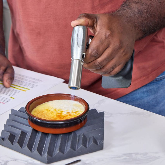 Person using a Messermeister Cheflamme Culinary Torch to torch food