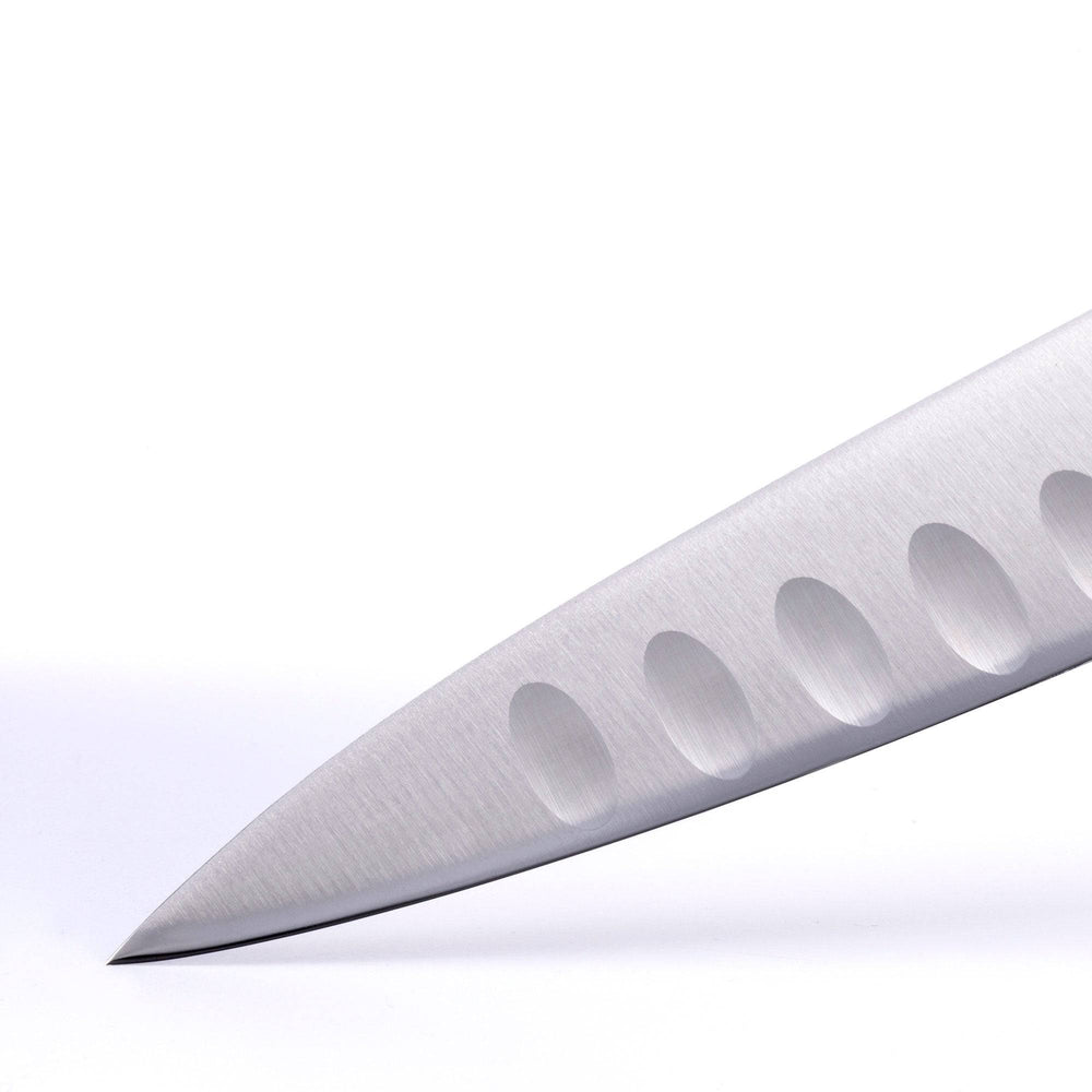 A close up of the 8 inch Meridian Elite Kullens carving knife showing the kullens and narrow spearpoint tip