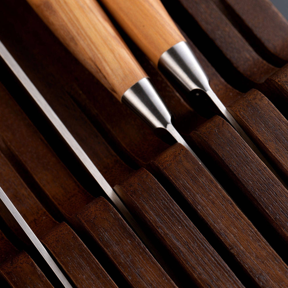 Messermeister 11 Slot Contemporary Acacia In-Drawer Knife Holder shows an extreme close up of 4 Olive Wood knives stored within the slots.