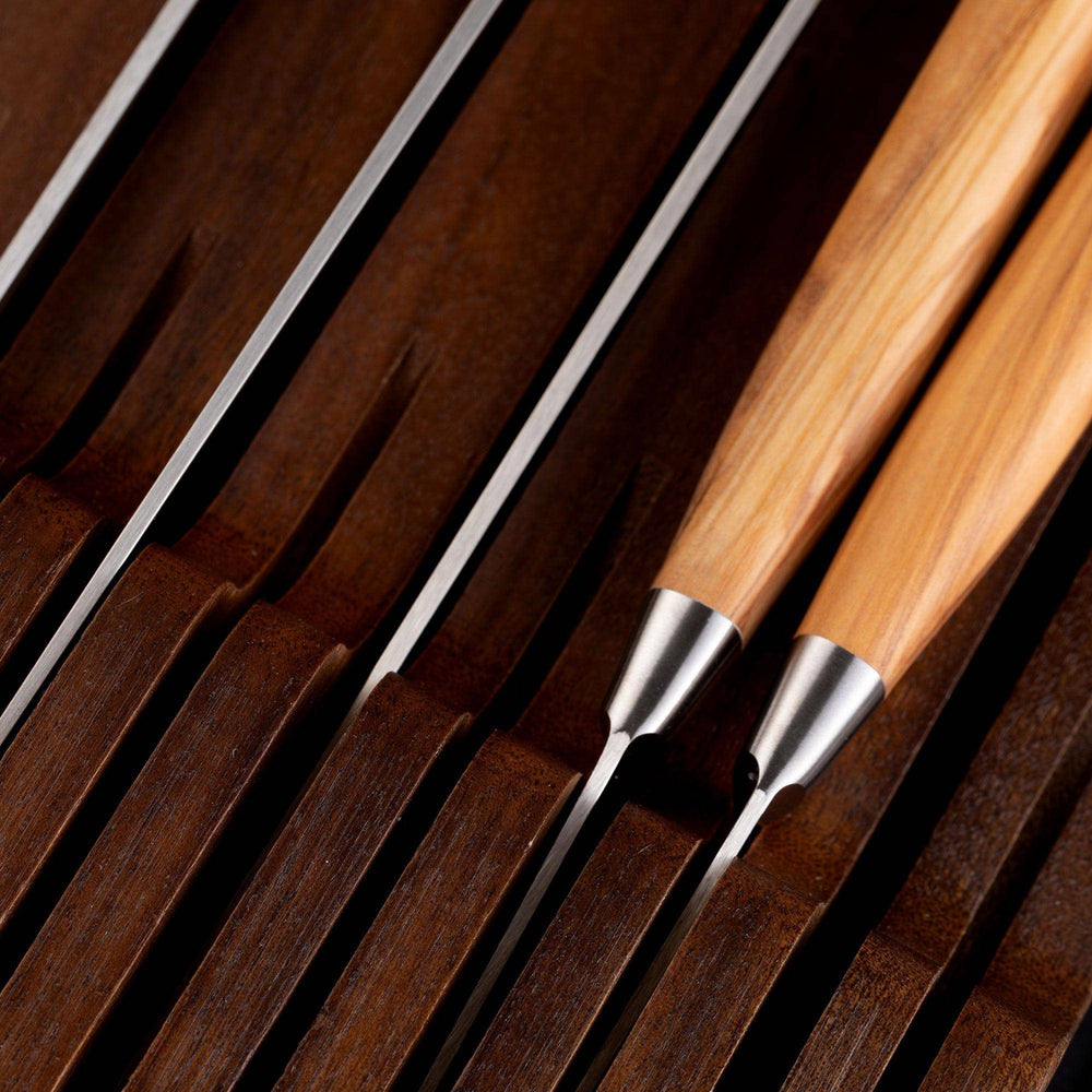 Messermeister 11 Slot Contemporary Acacia In-Drawer Knife Holder shows a close up of 5 Olive Wood knives situated within the slots. Knife handles pointing to the right.