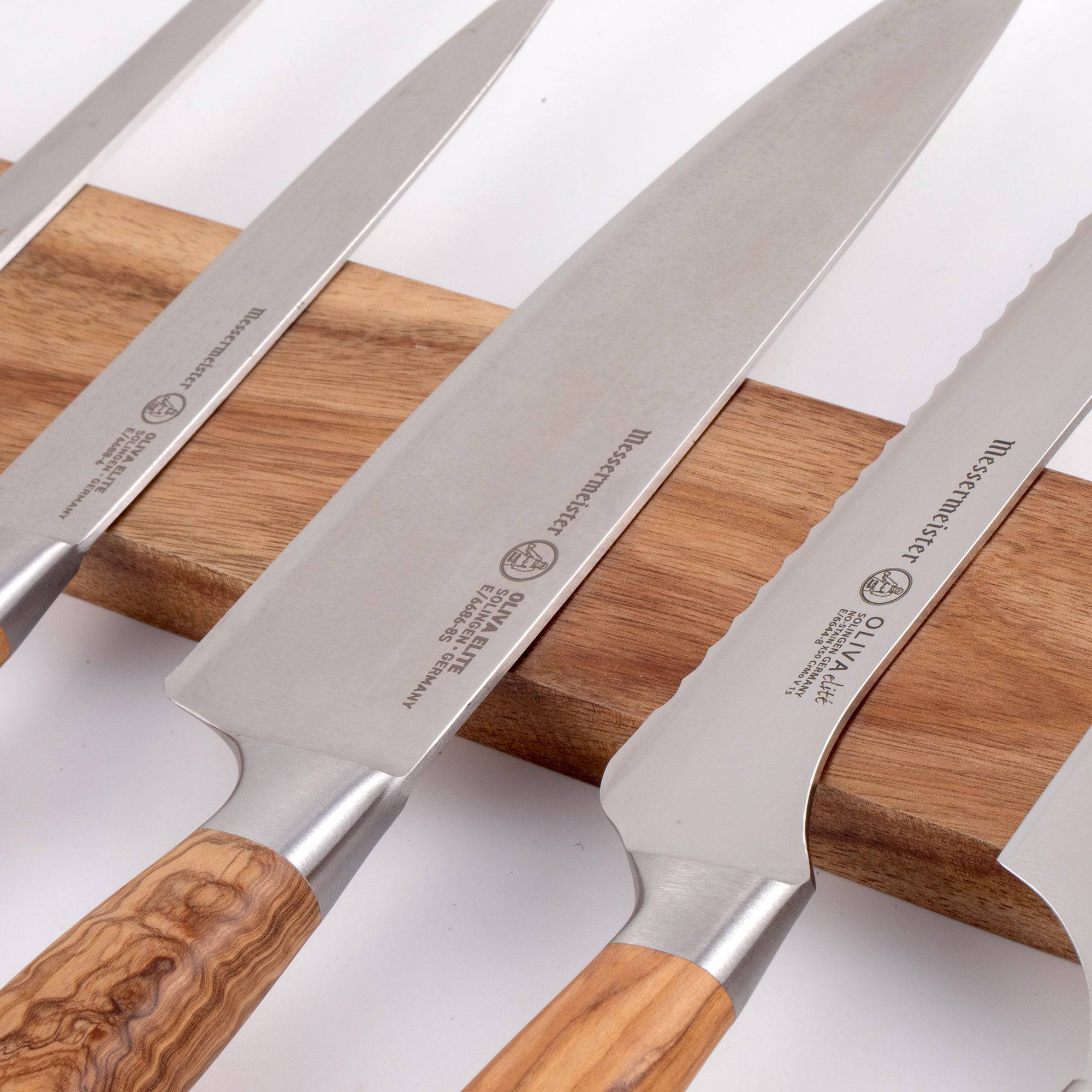 Messermeister Acacia Knife Magnet Bar close up of bar and 5 knife blades resting  on the top