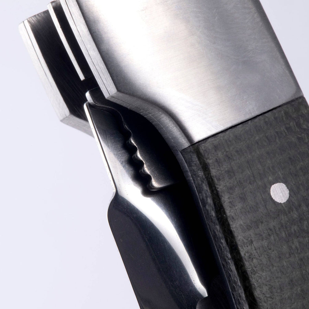 Close up view of the locking mechanism in the handle of the Messermeister Adventure Chef Folding Peeler and Parer