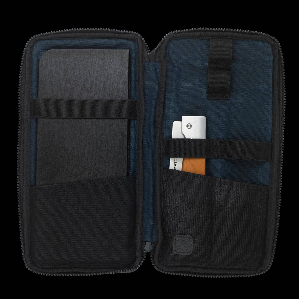 Messermeister Adventure Chef Maple Basecamp Set 3 Piece showing the 6 inch folding Chef's Knife and faux wood cutting board tucked inside the zippered carrying case