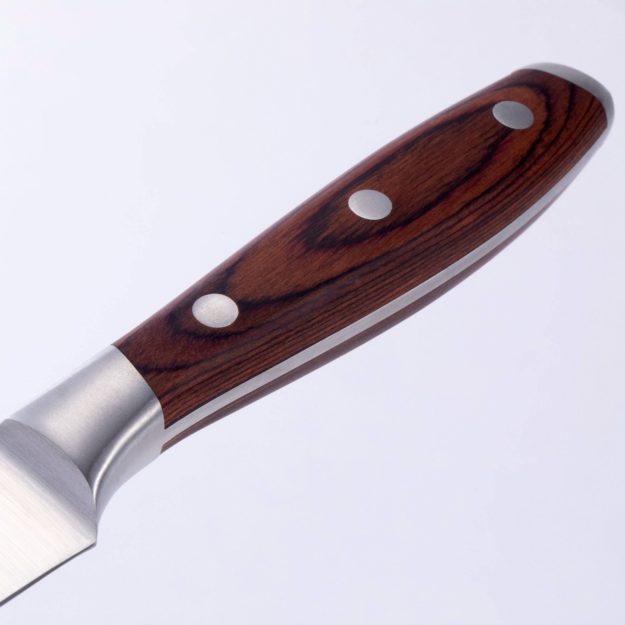 Close-up of Messermeister 4-piece steak knife set showing pakkawood handle texture detail