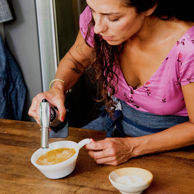 Messermeister Cheflamme Culinary Torch caramelizing the sugar topping on a crème brûlée, creating a crisp golden crust with a precise adjustable flame for professional dessert finishing and gourmet kitchen presentation