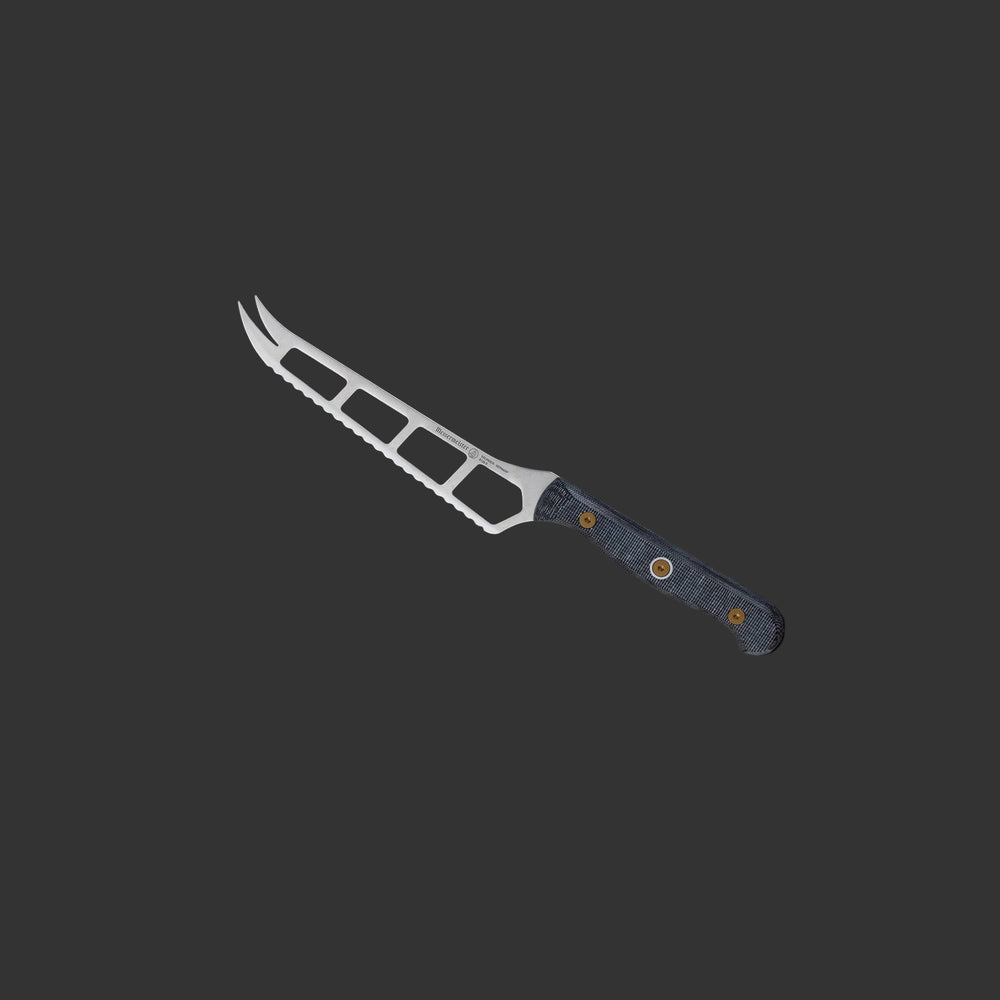 Messermeister Custom Cheese & Tomato Knife 5-inch angled upward, highlighting its serrated edge designed for clean cuts through soft cheese and tomatoes”