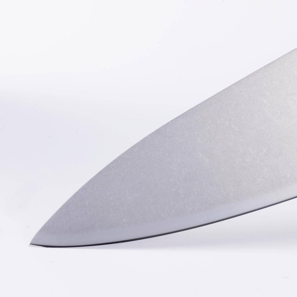 Close-up of Messermeister Custom knife tip highlighting fine point and polished steel blade edge