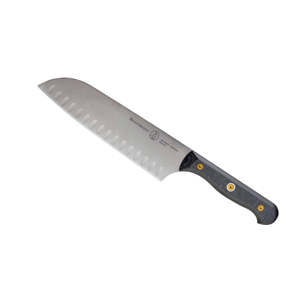 Angled-up view of Messermeister custom 7-inch santoku knife highlighting kullens and blade profile