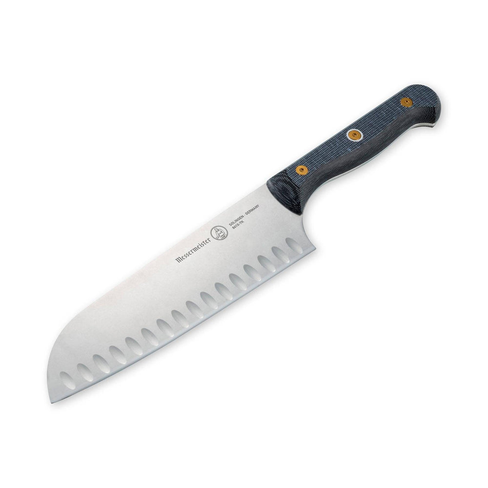 Angled-down close-up of Messermeister custom santoku knife highlighting kullens and precision blade edge
