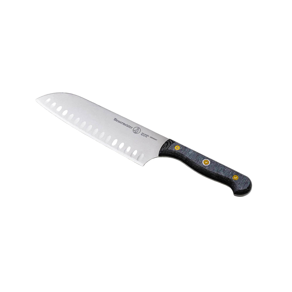 Messermeister 7-inch santoku knife angled up showing kullens (granton edge) and precision stainless steel blade and linen micarta handle