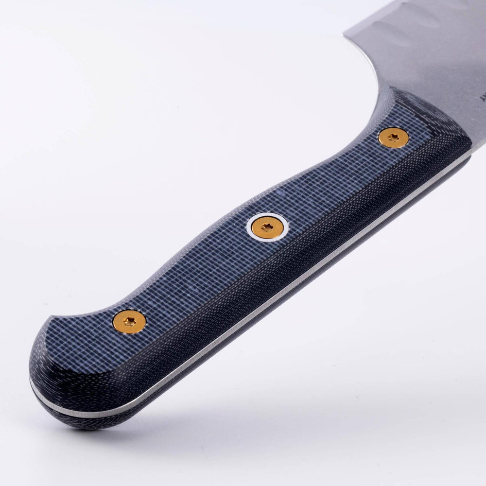 Close-up of Messermeister custom santoku knife handle highlighting textured ergonomic grip and linen micarta handle detail