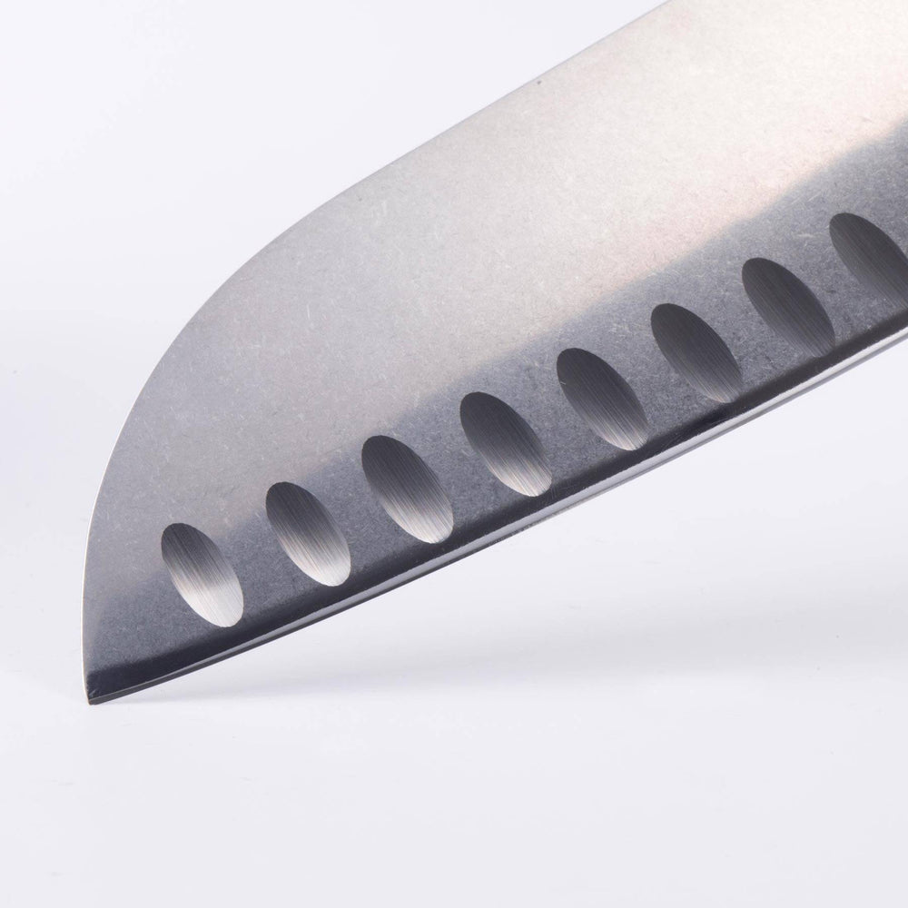Close-up of Messermeister custom santoku knife tip highlighting sharp blade point and kullens