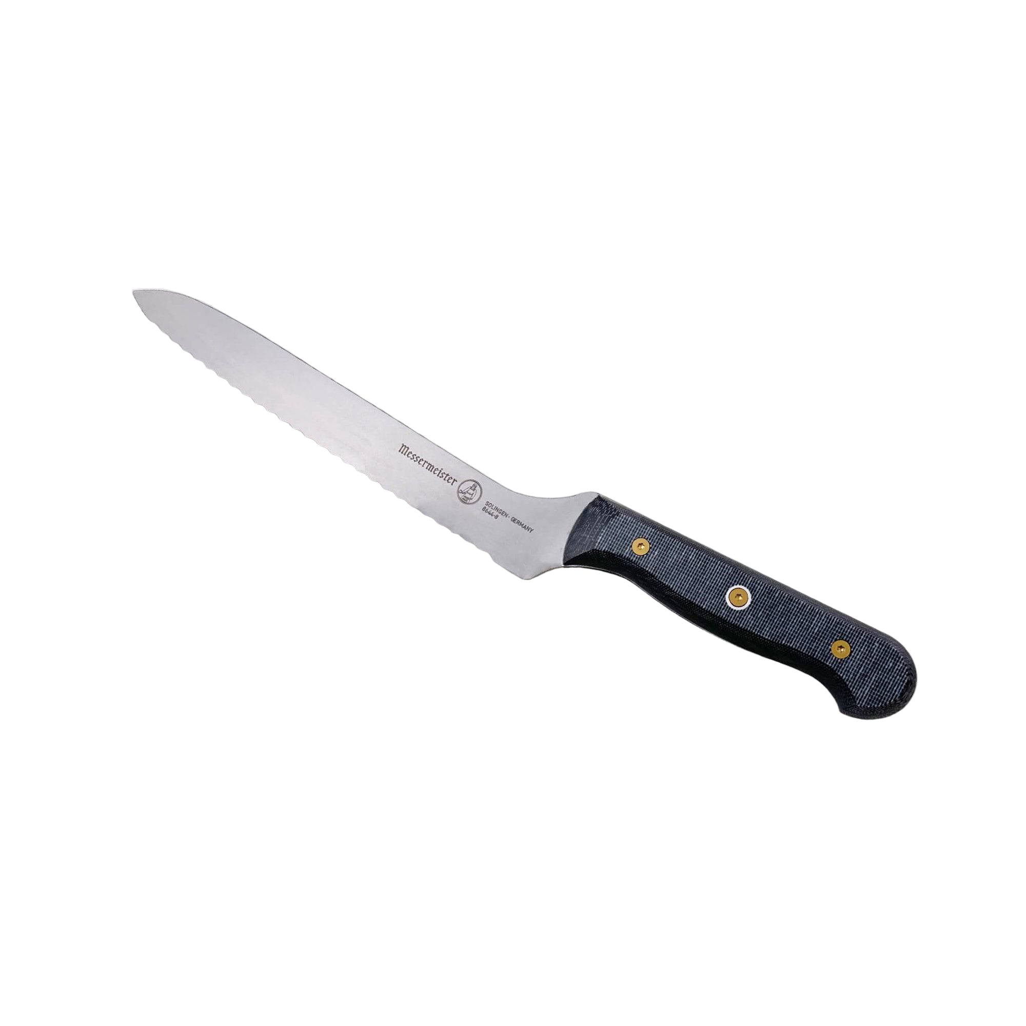 Angled view of Messermeister custom offset bread knife highlighting scalloped serrated edge and offset handle design
