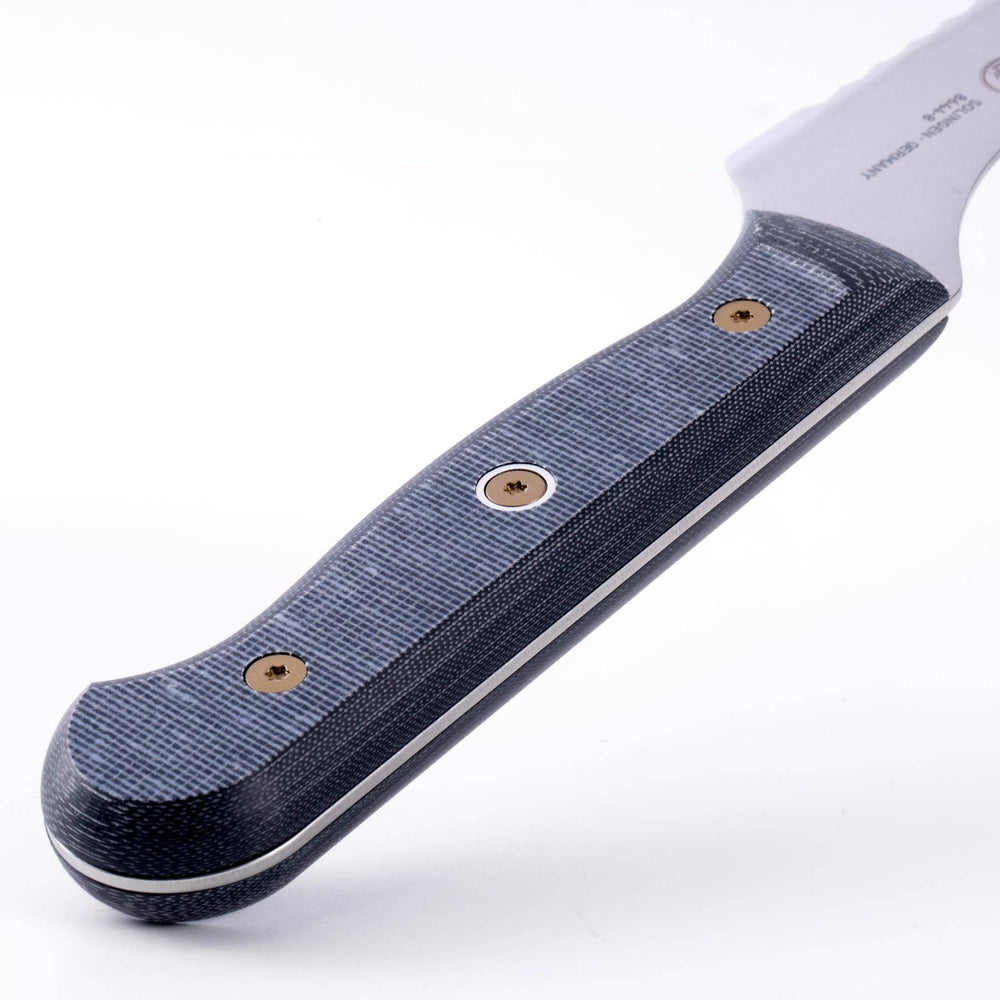 Close-up of Messermeister custom offset bread knife handle highlighting linen micarta textured ergonomic grip