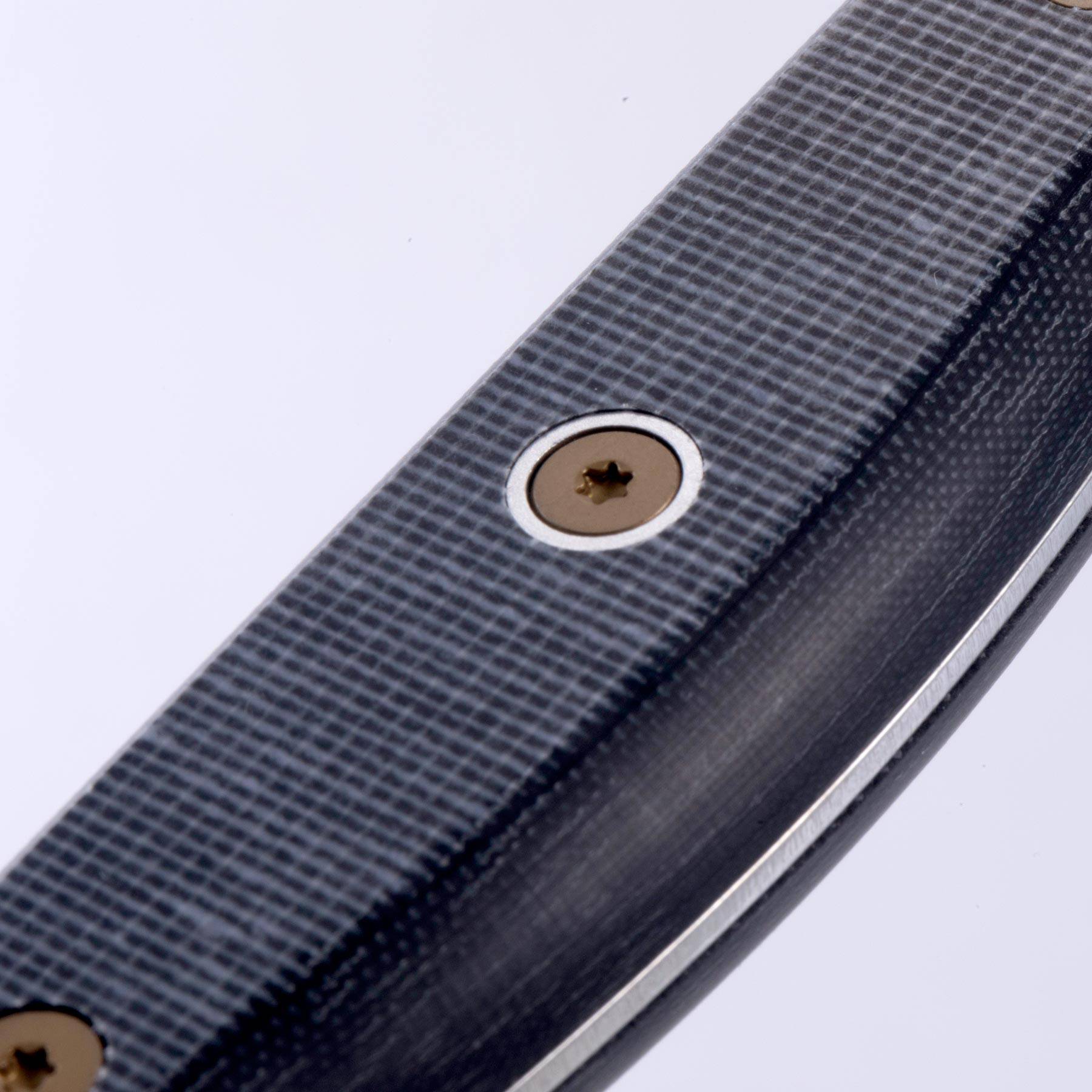 Close-up of knife handle highlighting removable rivets and precision handle construction