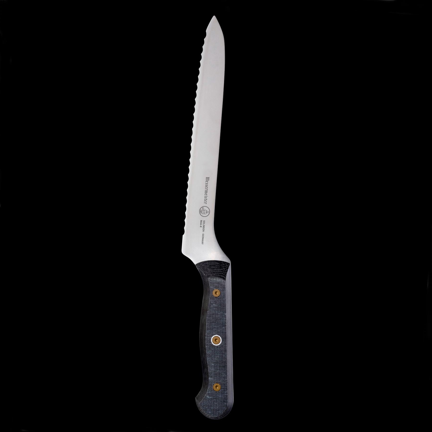 Upright view of Messermeister custom offset bread knife highlighting scalloped serrated edge and  linen micarta handle