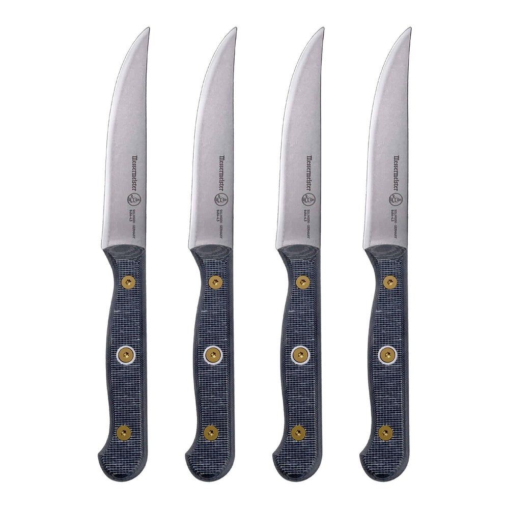 Up-close view of a four-piece Messermeister Custom steak knife set with 5-inch blades highlighting the sharp stainless steel edges and ergonomic modular handles with textured linen micarta scales