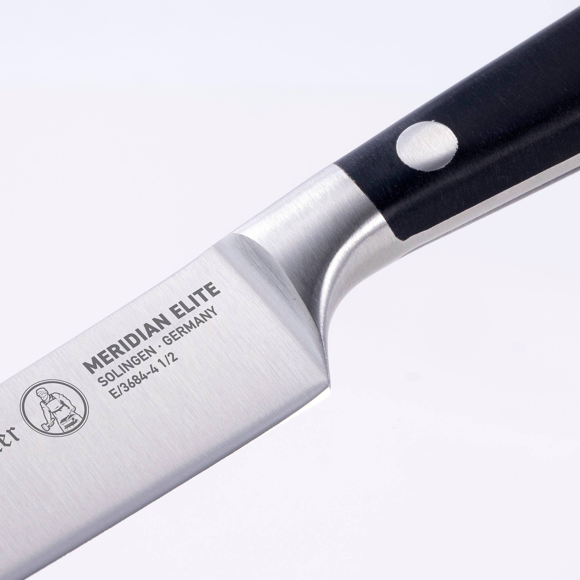 A close up view of the bolster and heel of the Meridian Elite fine edge steak knife logo showing