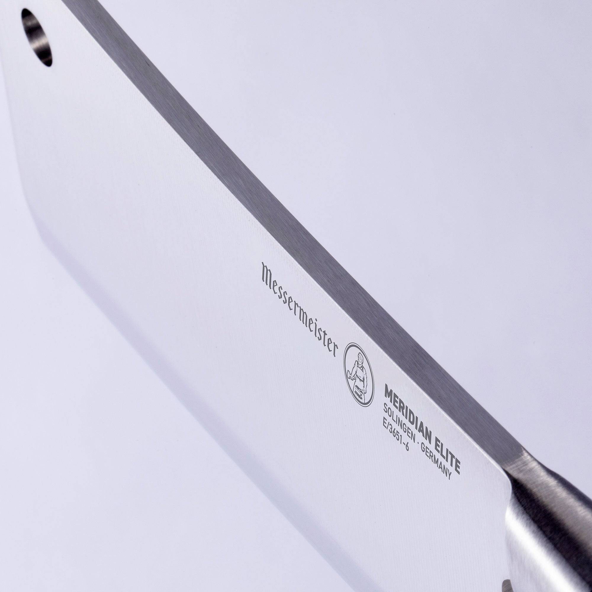 Close up view of the spine of the Meridian Elite 6 inch heavy cleaver showing blade thickness and a small hook hole in upper front corner of blade