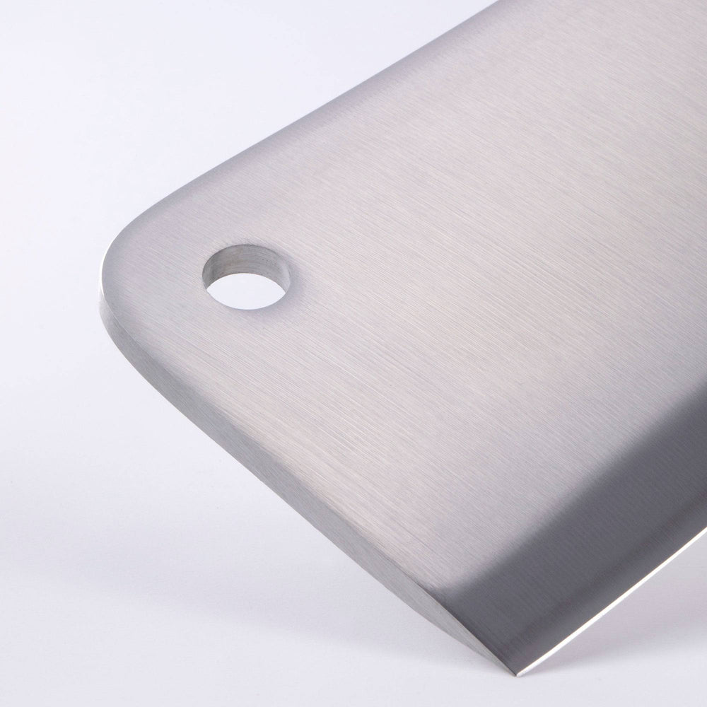 Close up view of the tip of the Meridian Elite 6 inch heavy cleaver showing blade thickness and a small hook hole in upper front corner of blade