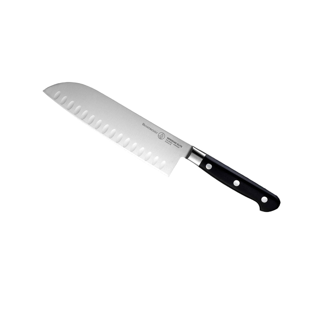 An angled view of the 7 inch Meridian Elite Kullens Santoku Knife with a Japanese chef's design, featuring a silver blade with kullens on the side and a triple rivet black handle. 