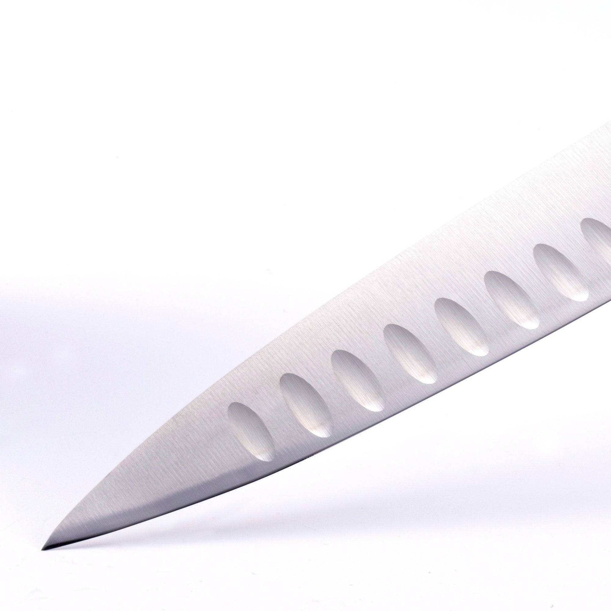 A close up of the 10 inch Meridian Elite Kullens carving knife showing the kullens and narrow spearpoint tip