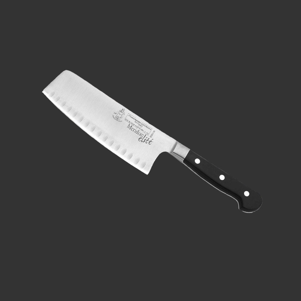 Angled view of the Meridian Elite 7 inch Kullens Vegetable Knife featuring a silver blade with kullens on the side and a triple rivet black handle