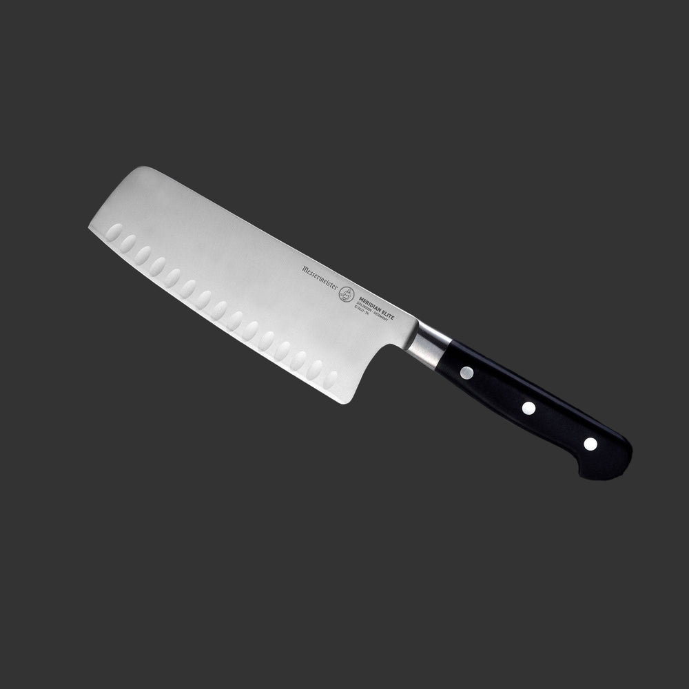 Angled view of the Meridian Elite 7 inch Kullens Vegetable Knife featuring a silver blade with kullens on the side and a triple rivet black handle.
