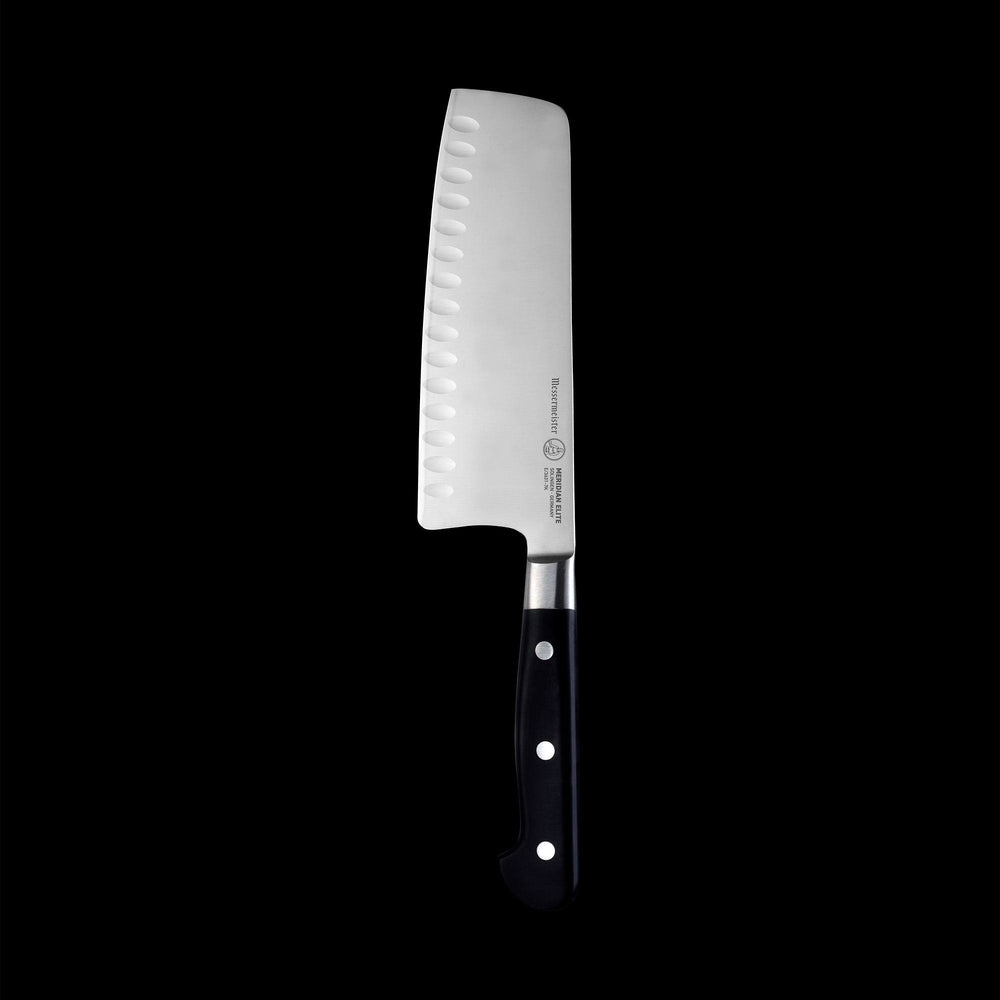 Vertical view of the Meridian Elite 7 inch Kullens Vegetable Knife featuring a silver blade with kullens on the side and a triple rivet black handle.