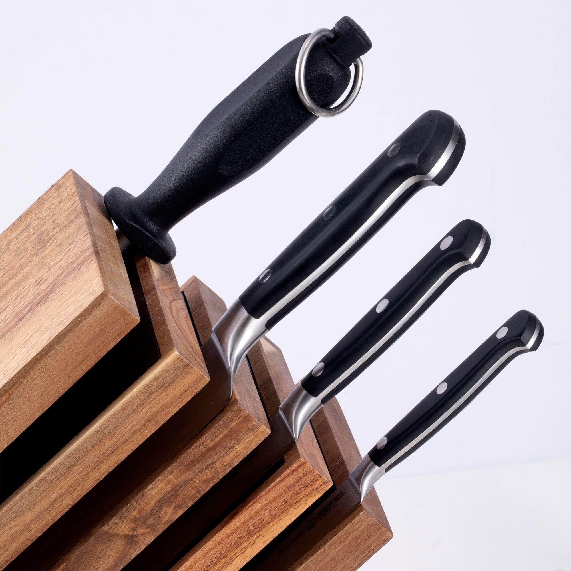 Messermeister Meridian Elite Next Level Block Set - 5 Piece set close up of triple rivet black handles and solid black handle on the honing steel