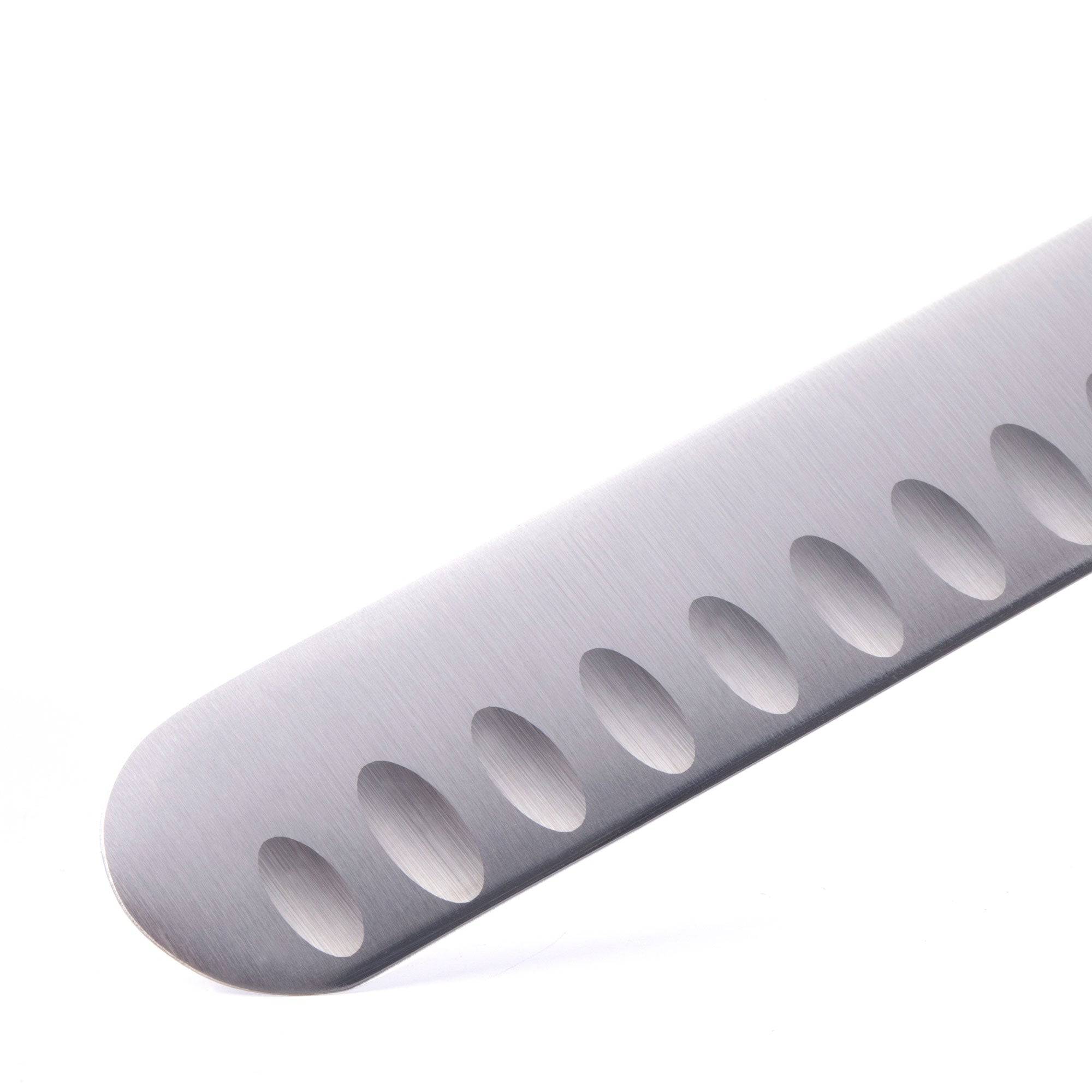 A close up view of the tip of the 10 inch Messermeister Meridian Elite Round Tip Kullens Slicer showing kullens