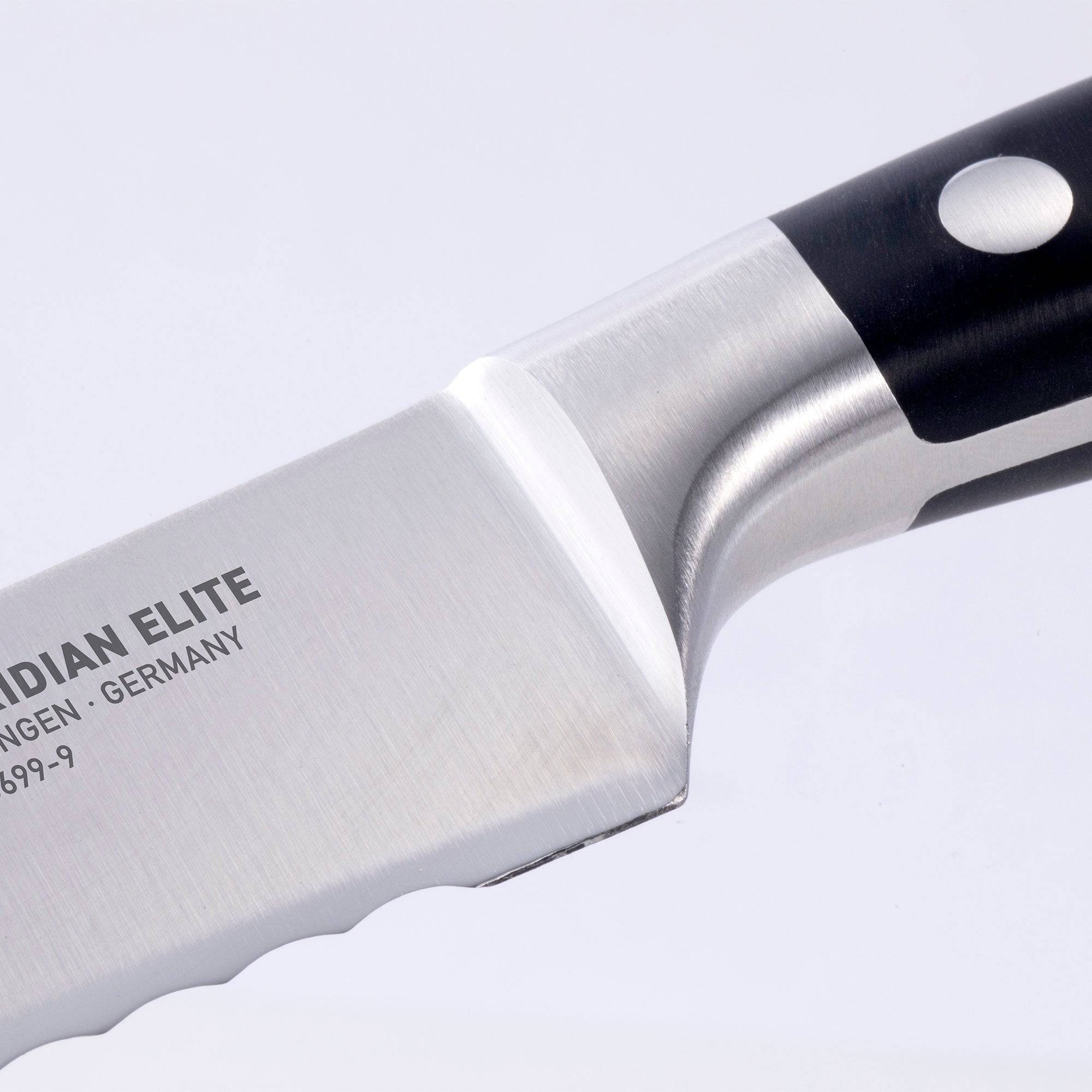 Close up view of the Meridian Elite 9 inch serrated bread knife tip showing the bolster and heel