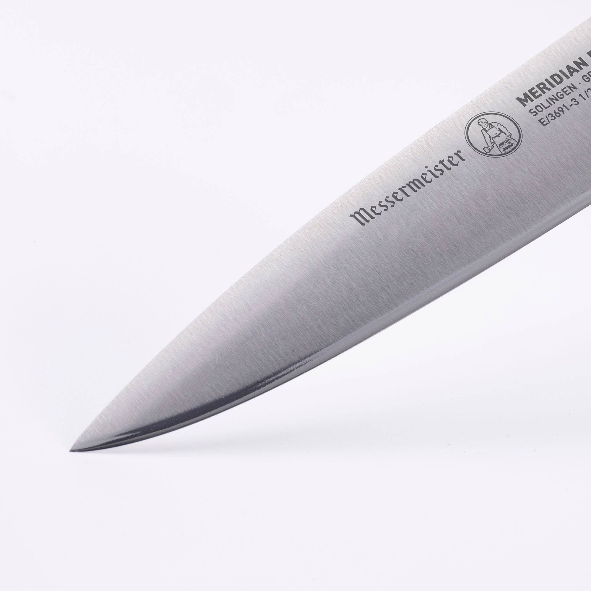The Meridian Elite 3.5 inch Paring Knife close up view of tip and logo