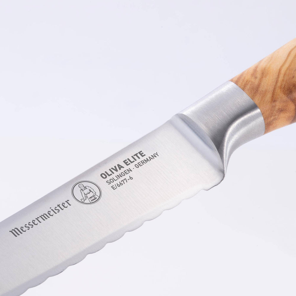 Close up of the Oliva Elite 6 inch Reverse Scallop Utility Knife showing bolster and heel with logo
